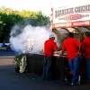 Three Men Making Manning The Barbecue